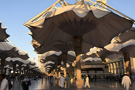 Travelers Enjoying the 3 Star Umrah Experience with Guided Tours and Group Activities